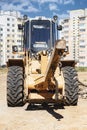 Powerful wheel loader for transporting bulky goods at the construction site of a modern residential area. Construction equipment Royalty Free Stock Photo