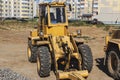 Powerful wheel loader for transporting bulky goods at the construction site of a modern residential area. Construction equipment Royalty Free Stock Photo