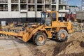 Powerful wheel loader for transporting bulky goods at the construction site of a modern residential area. Construction equipment Royalty Free Stock Photo