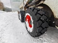 Powerful wheels of a snowplow tractor on the snow. Royalty Free Stock Photo