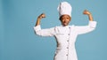 Powerful woman cook flexing arm muscles on camera