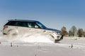 Powerful 4x4 offroader car running on snow field Royalty Free Stock Photo