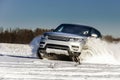 Powerful 4x4 offroader car running on snow field Royalty Free Stock Photo