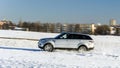 Powerful 4x4 offroader car running on snow field