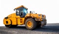 A powerful yellow road roller on an asphalt surface, ready for heavy-duty work Royalty Free Stock Photo