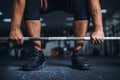 Powerlifter prepares for deadlift a barbell in gym