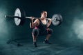 Powerlifter in sportswear doing squat with barbell