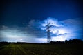 Powerlines in front of a Thunderstorm over a field Royalty Free Stock Photo