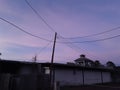 Powerlines purple and pink sunset building Royalty Free Stock Photo