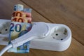 Powerstrip, plugs and Euro banknotes to illustrate the rise of the electricity and daily life expenses Royalty Free Stock Photo