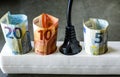 Powerstrip with plugs and Euro banknotes to illustrate the rise of electricity and daily life expenses Royalty Free Stock Photo