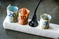 Powerstrip with plugs and Euro banknotes to illustrate the rise of electricity and daily life expenses Royalty Free Stock Photo