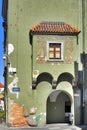 The green facade of the house with drawings and arches in the old house