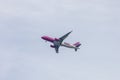 Upward view to landing Wizzair aeroplane