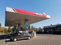 Shot of tanking cars at an Orlen fuel station in Poznan, Poland on a sunny day Royalty Free Stock Photo