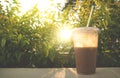 Pozol - Mexican chocolate corn drink in plastic cup with sun backlight