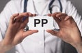 PP vitamin, word acronym on paper in hands