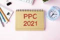 PPC ,Pay Per Click, is an acronym written on white paper on an office desk with a calculator, markers, Royalty Free Stock Photo