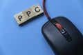 PPC Pay Per Click with alphabet and mouse on blue background Royalty Free Stock Photo