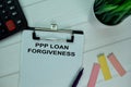 PPP Loan Forgiveness write on a paperwork isolated on office desk Royalty Free Stock Photo