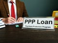 PPP loan and Paycheck Protection Program title on the plate in the office Royalty Free Stock Photo