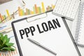 ppp loan text on white paper with charts and pen Royalty Free Stock Photo