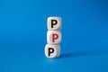 PPP private public partnership symbol. Wooden cubes with words PPP. Beautiful blue background. Business and PPP concept. Copy