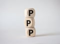 PPP private public partnership symbol. Wooden cubes with words PPP. Beautiful white background. Business and PPP concept. Copy