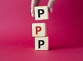PPP private public partnership symbol. Wooden cubes with words PPP. Businessman hand. Beautiful red background. Business and PPP
