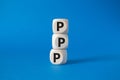 PPP private public partnership symbol. Wooden cubes with words PPP. Beautiful blue background. Business and PPP concept. Copy