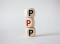 PPP private public partnership symbol. Wooden cubes with words PPP. Beautiful white background. Business and PPP concept. Copy