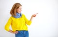 Ppy young woman in yellow sweater on white background