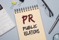 PR acronym word on paper. Public Relations concept