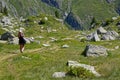 Young hiker walk on paths among the rocks in Belledonne mountain range
