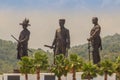 Prachuap Khiri Khan, Thailand - March 16, 2017: The bronze statues three of seven Thai kings in the mountain and blue sky Royalty Free Stock Photo