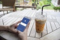 Prachuapkhirikhan,thailand-august 6,2016: woman hand holding a smartphone with Facebook page on screen,at coffee cafe