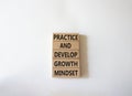 Practice and Develop growth mindset symbol. Wooden blocks with words Practice and Develop growth mindset. Beautiful white