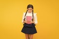 Practice and improve reading skills for school studies. Back to school concept. Girl hold book. School girl on yellow Royalty Free Stock Photo