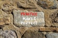 Practice makes perfect symbol. Concept words Practice makes perfect on beautiful big stone on stone wall. Beautiful stone wall