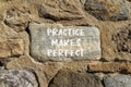 Practice makes perfect symbol. Concept words Practice makes perfect on beautiful big stone on stone wall. Beautiful stone wall