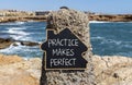 Practice makes perfect symbol. Concept words Practice makes perfect on beautiful black chalk blackboard. Beautiful stone sea sky