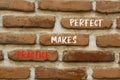 Practice makes perfect symbol. Concept words Practice makes perfect on beautiful brown brick. Beautiful red brown brickwall