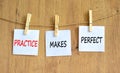 Practice makes perfect symbol. Concept words Practice makes perfect on beautiful white paper on clothespin. Beautiful wooden