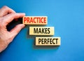 Practice makes perfect symbol. Concept words Practice makes perfect on wooden block. Beautiful blue table blue background.