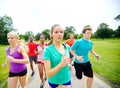 Practice marathon. Front view of a group of male and female athletes outside.