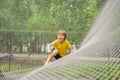 practice nets playground. boy plays in the playground shielded with a protective safety net. concept of children on line Royalty Free Stock Photo