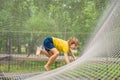 practice nets playground. boy plays in the playground shielded with a protective safety net. concept of children on line Royalty Free Stock Photo