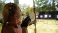 Practice and training of archery in shooting range. Sport woman in shooting range with bow. Outdoor archery training Royalty Free Stock Photo