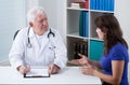 Practiced doctor talking with patient