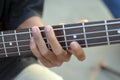 Practicing in playing bass guitar. Close up of man hand playing bass guitar. Royalty Free Stock Photo